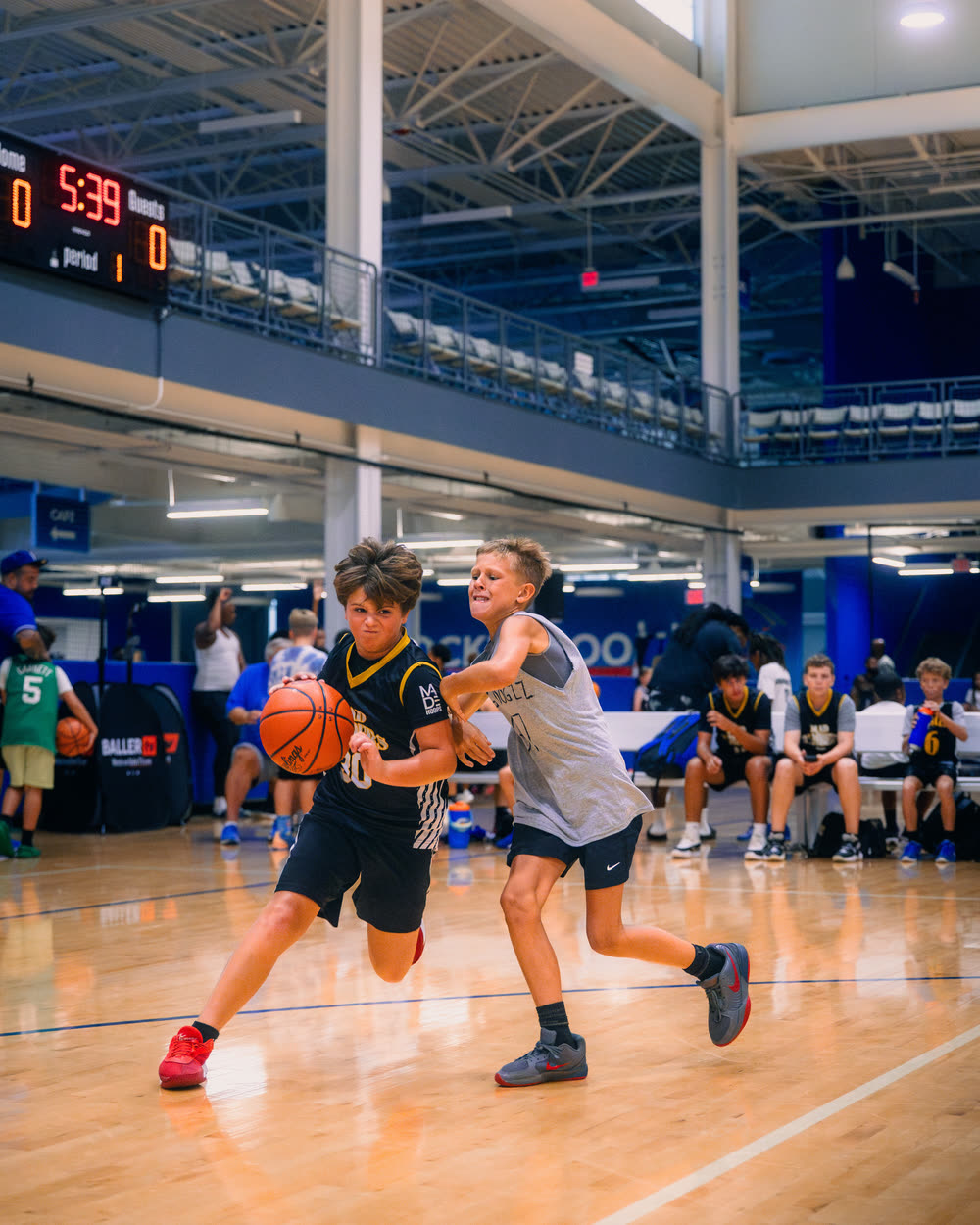 A G.O.A.T Training athlete drives to the basket past a defender during 3-on-3 play